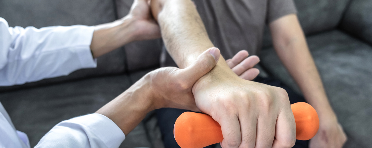 patient holding hand weight