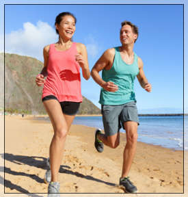 woman and man running on the beach