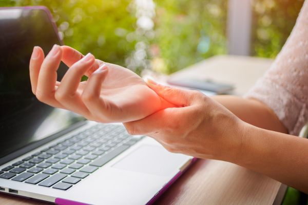 woman holding wrist in pain